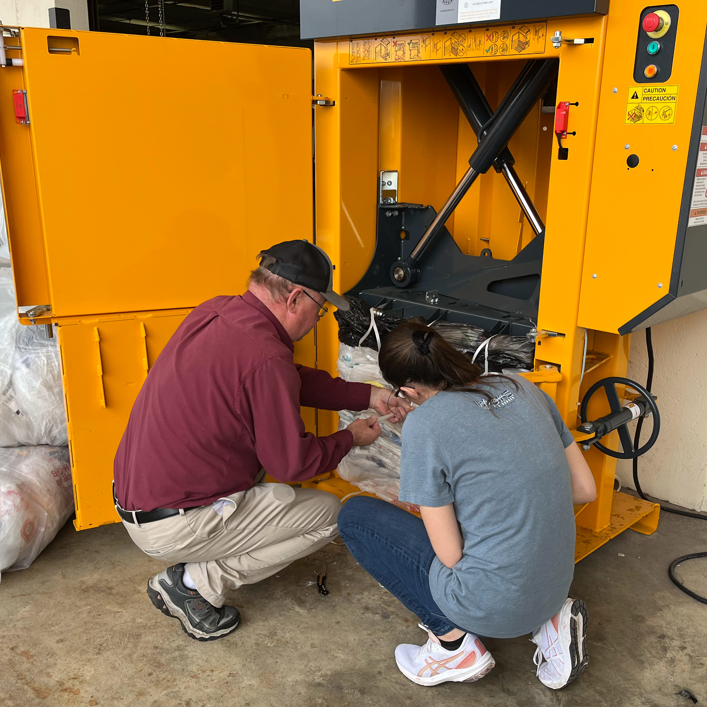 plastic film baler with two people